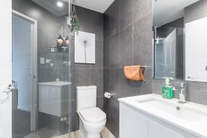 a bathroom with a toilet and a sink and a shower at 2BR Apt in Hurstville 1Min To Train Station Sleep 8 in Sydney +45 photos