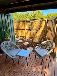 two chairs and a garden on a deck at Heart of Witchcliffe in Margaret River Town