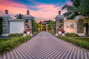 a driveway leading to a villa at sunset at The Palace by Ocean in Bentota