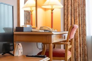 a desk in a hotel room with a mirror at Lotte Hotel Busan in Busan