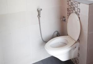a bathroom with a toilet with a shower at Campper Campwoody Munnar in Munnar