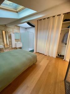 a bedroom with a large bed and a closet at Les Capucins in Bordeaux