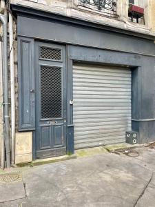 a garage door on a building with a door opener at Les Capucins in Bordeaux