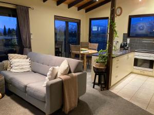 a living room with a couch and a kitchen at TekapoB2 Lakeview Apartment in Lake Tekapo +31 photos