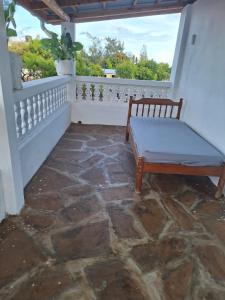 een bankje op het balkon van een huis bij Cool breeze in Ukunda