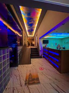 a lobby with a bar and a ceiling with blue lights at Elit Palace Hotel in Istanbul