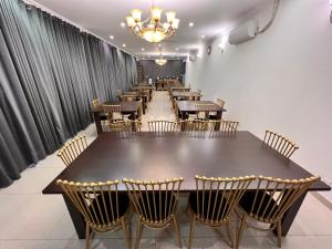 a dining room with a large table and chairs at Rhodium Hotel ONE in Islamabad