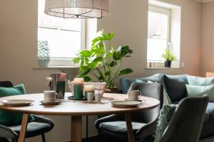 a dining room table with chairs and a couch at Idyllische Ferienwohnung im Kraichgau in Sinsheim