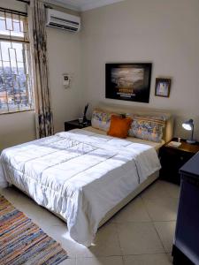 a bedroom with a large bed in a room at Olive Escapes in Dar es Salaam