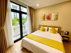 a bedroom with a bed and a large window at Teddy 96 Homestay & Cafe-3 stars-Grand World Phu Quoc in Phu Quoc