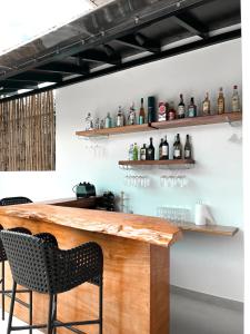 a bar with two chairs and a counter with bottles at Go Boutique Inn in Puerto Princesa City
