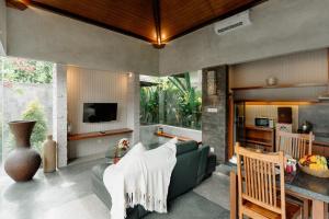 a living room with a couch and a table at Bracha Villas Bali - CHSE Certified in Seminyak
