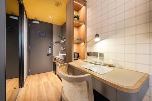 a kitchen with a counter and a table and chairs at Dash Living on Hollywood in Hong Kong