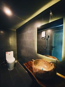 a bathroom with a large sink and a toilet at Hoa Son Village Da Lat in Xuan An