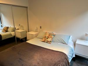 a bedroom with a bed with a pillow on it at Lovely 2 bedrm apartment in Auckland's viaduct in Auckland