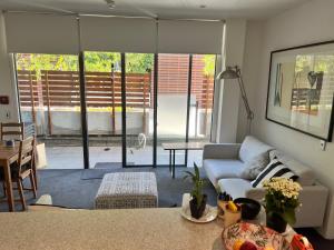 a living room with a couch and a table at Lovely 2 bedrm apartment in Auckland's viaduct in Auckland