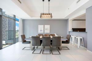 a dining room with a table and chairs at FAM Living - Mada Residences Downtown Dubai in Dubai