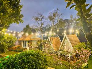 a group of houses in a garden at night at Hoa Son Village Da Lat in Xuan An