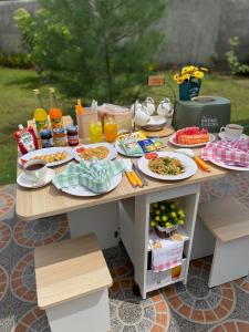 uma mesa com pratos de comida e bebidas em Breeze House em Prampuan