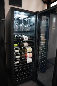 a refrigerator filled with lots of bottles of wine at Perle Vendégház in Kesztölc