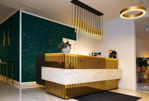 a lobby with a yellow and white reception desk at M-Pire Hotel Berlin in Berlin