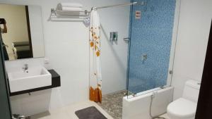 a bathroom with a shower and a toilet and a sink at HOTEL ANEKA BARU in Sleman