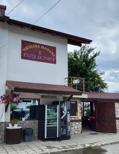 a building with a vending machine in front of it at Чилковата Къща in Banya