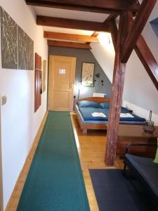 a room with a green floor in a attic at Guest House Olšakovský in Český Krumlov