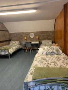 a bedroom with two beds and a desk in it at Black Mountain Family Room in Velindre