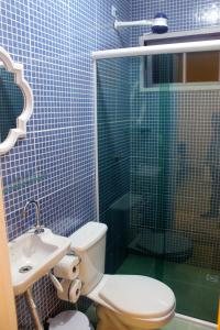 a bathroom with a toilet and a sink and a shower at Pouso do Sopé in Paraty