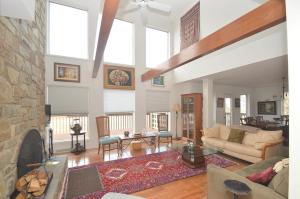 a large living room with a stone fireplace at Panorama Peak View- Wifi, Screen Porch, Million Dollar View, Fireplace, Full Kitchen in Berkeley Springs +26 photos