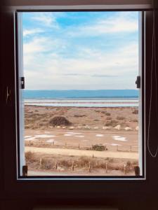 a window in a room with a view of a field at Tropical Duplex : Bord de mer + Piscine in Frontignan