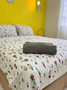 a bed with a comforter with butterflies on it at SEAVIEW HOLIDAY APARTMENT 4 - WiFi & Netflix in Kuala Terengganu