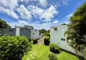 a view of two buildings in a yard at 3 bedroom Villa - Private and Spacious in Pointe aux Canonniers