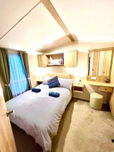 1 dormitorio con 1 cama grande con almohadas azules en The Beach Retreat en Par