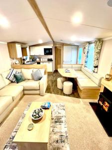 a living room with a couch and a table at The Beach Retreat in Par