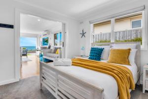 a bedroom with a large bed with a view of the ocean at Talisman Ocean views in Portland