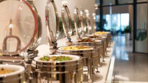 a row of plates of food on a buffet at The Oceanfront Apartment At Cam Ranh in Cam Ranh
