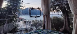 a bedroom with a window with a view of the water at Counting Stars in Recco