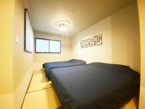 Cama o camas de una habitación en KAMON INN AIHUKA