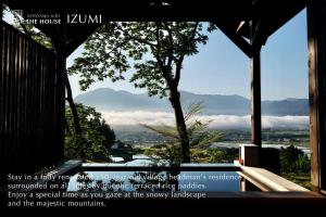 a large window with a view of a mountain at Satoyama Jujo The House in Minami Uonuma