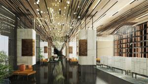 a lobby with tables and chairs in a building at Mövenpick Hotel Jakarta City Centre in Jakarta