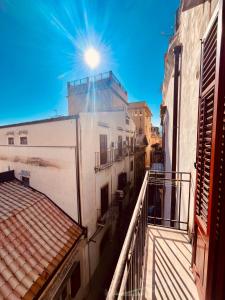 a view from a balcony of a building with the sun at Cathedral City Center Palermo 3 in Palermo