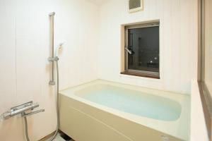 a bath tub in a bathroom with a window at The Archaic / Luxury apartment near Shinjuku in Tokyo +43 photos