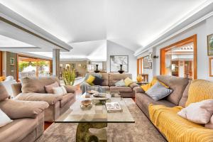 a living room with couches and a table at Exclusive Home Maspalomas in San Bartolomé +40 photos