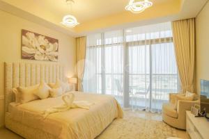 a bedroom with a large bed with a large window at Elegant Studio at Aykon City Tower - C in Dubai