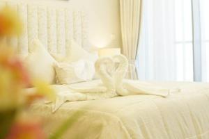 a white bed with white sheets and pillows at Elegant Studio at Aykon City Tower - C in Dubai