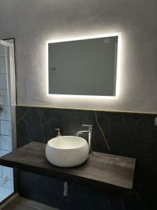 a bathroom with a sink and a mirror on a counter at Agriturismo B&B La Cerasa in Fabriano