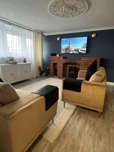 a living room with two couches and a tv at Birminghams Finest in Birmingham