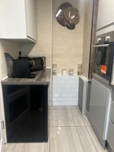 a kitchen with a counter top with a microwave at Birminghams Finest in Birmingham +9 photos